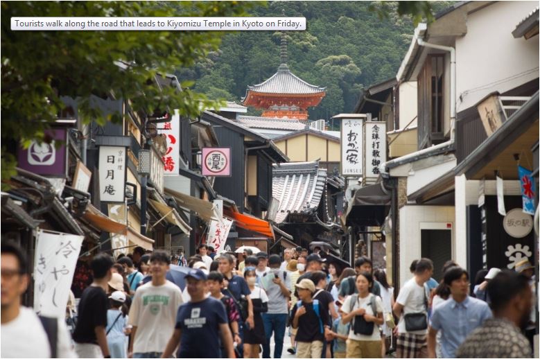 گردشگران روز جمعه در امتداد جاده ای که به معبد کیومیزو در کیوتو منتهی می شود قدم می زنند.